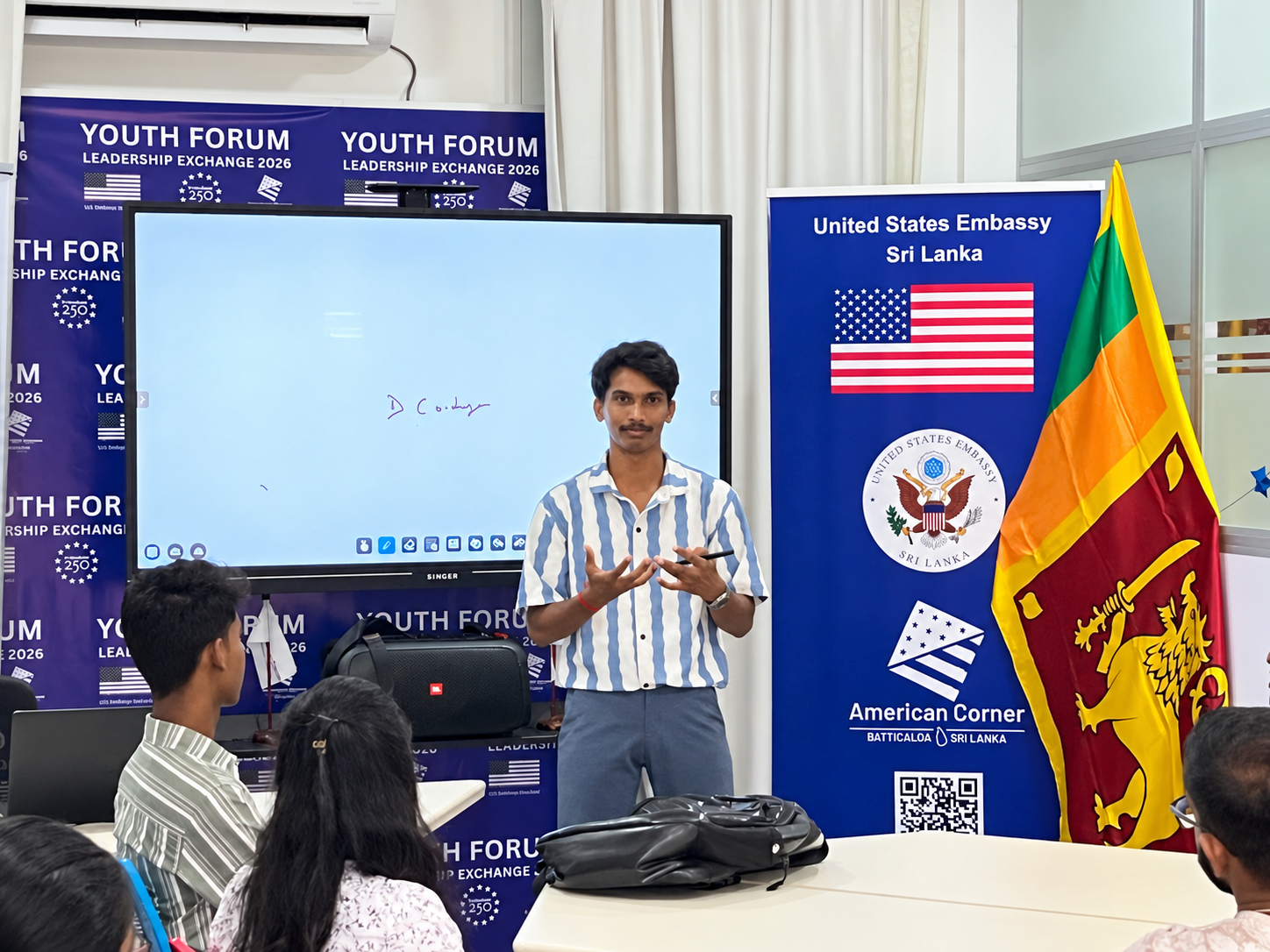 Facilitator presenting to participants during a hands-on youth workshop in Batticaloa